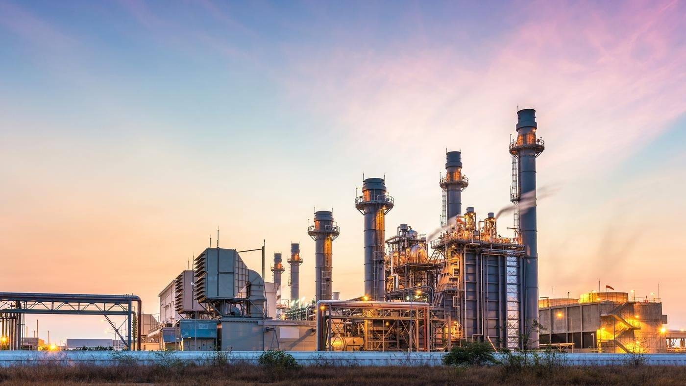 A large industrial plant at sunset.