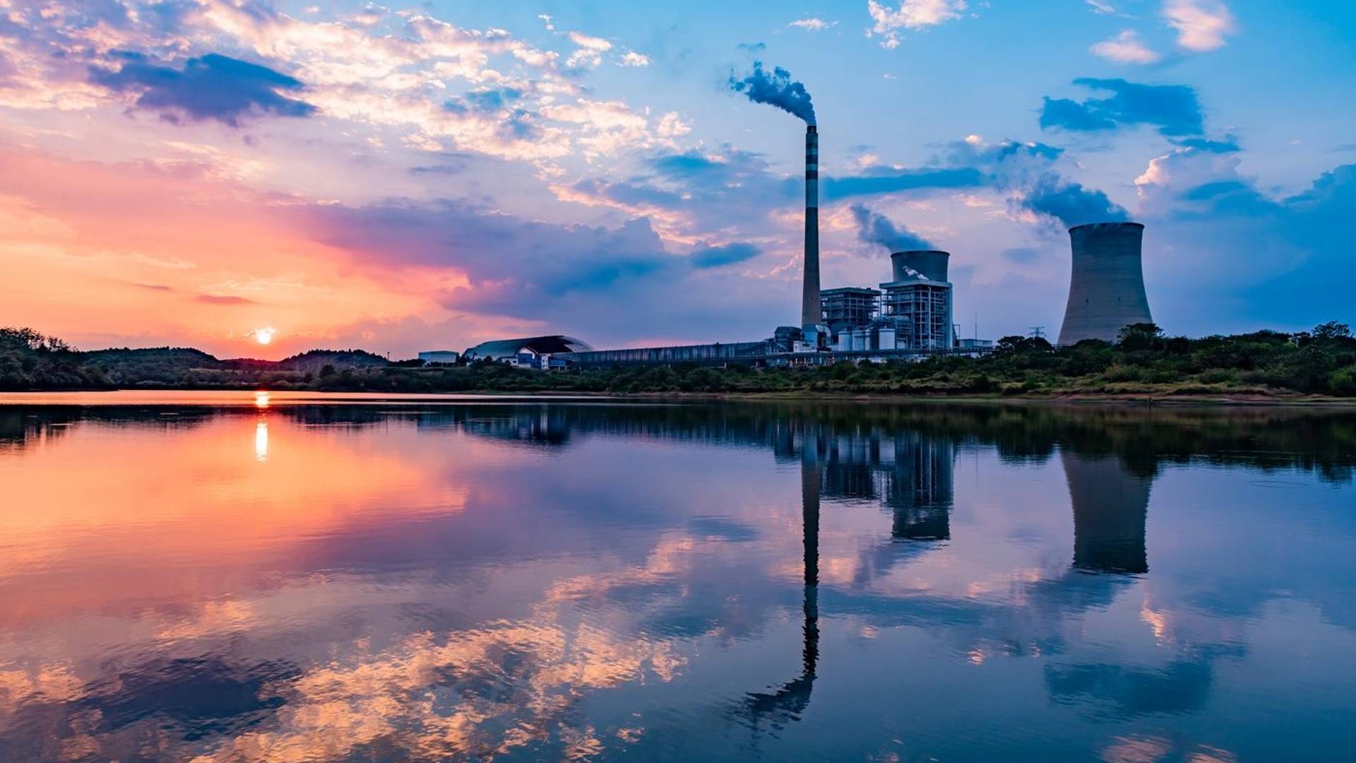 Nuclear power plant after sunset. Dusk landscape with big chimneys.