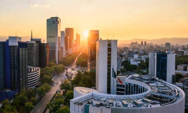 Office buildings, with the Popocatépetl mountains in the background at sunrise. Mexico City, Mexico.