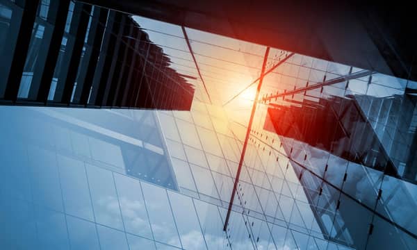 Skyscraper or modern building in the city with sunlight reflecting on the glass facade.