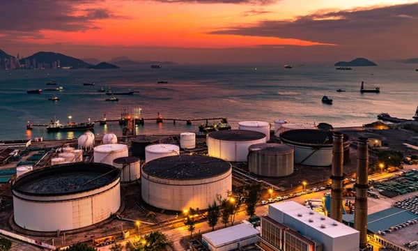 The tank is in the light of the industrial area. With the sky of the sunset.