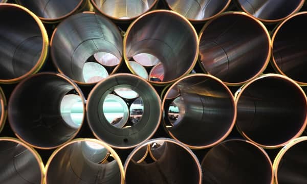 Stacked rows of metallic tubes.