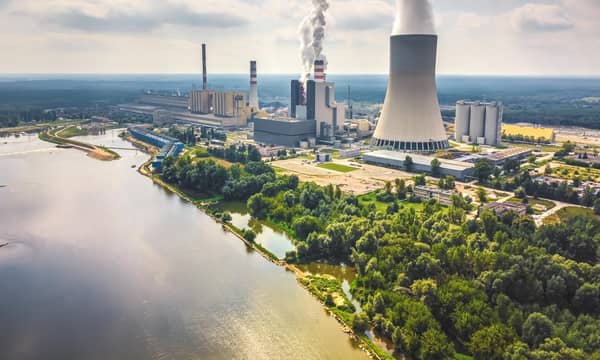 Large nuclear power station with steam coming from cooling tower. Drone, aerial view