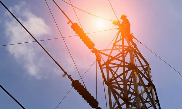 A man is working on a high voltage power line.