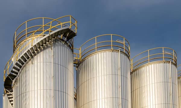 A group of metal silos in a factory.