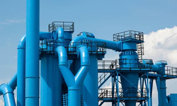 Blue industrial pipes of the exterior of a factory.