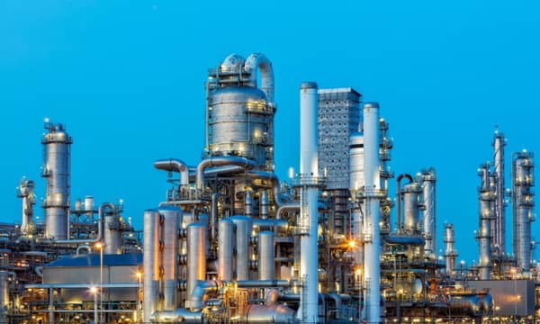 A large, modern petrochemical plant at dusk in industrial district near Rotterdam, Netherlands, Benelux, Europe. Distillation towers and other installations are visible against blue sky. 50 megapixel image taken with Canon EOS 5Ds, digital blending technique, long exposure with tripod.