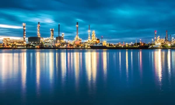 Panorama of Oil refinery with reflection from the river it sits next to.