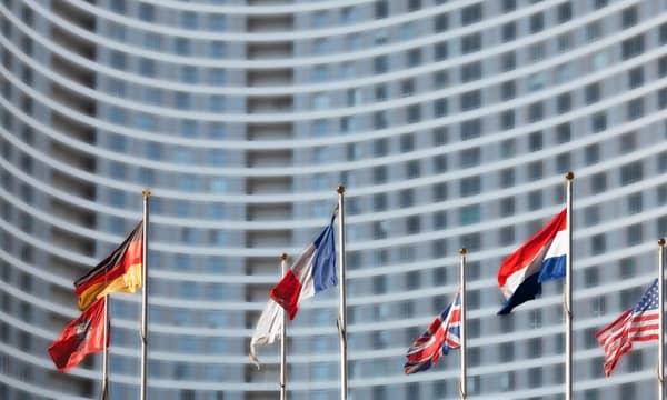 International flags in front of high-rise building.