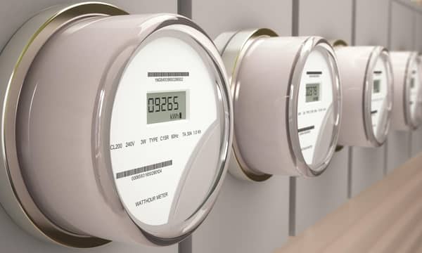 A row of digital watts per hour meters on a wall.