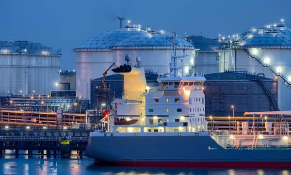 Liquid Natural Gas storage tanks and tanker at dusk, Port of Rotterdam.
