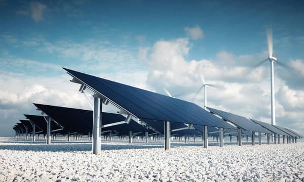 Solar panels and wind turbines in the desert.