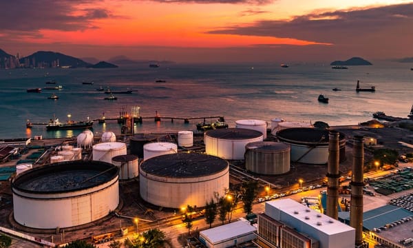 The tank is in the light of the industrial area. With the sky of the sunset.