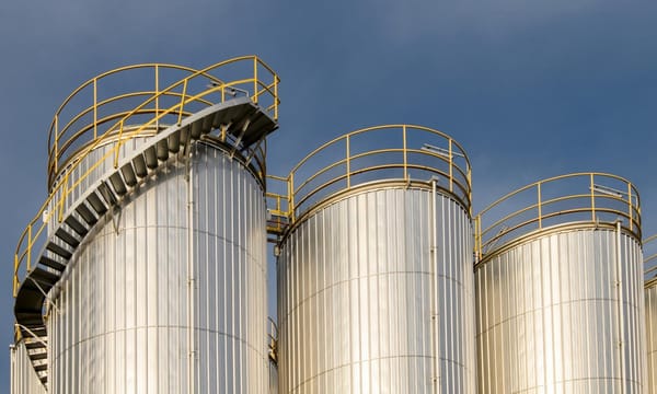 A group of metal silos in a factory.