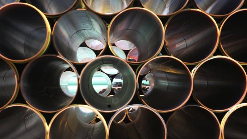 Stacked rows of metallic tubes.