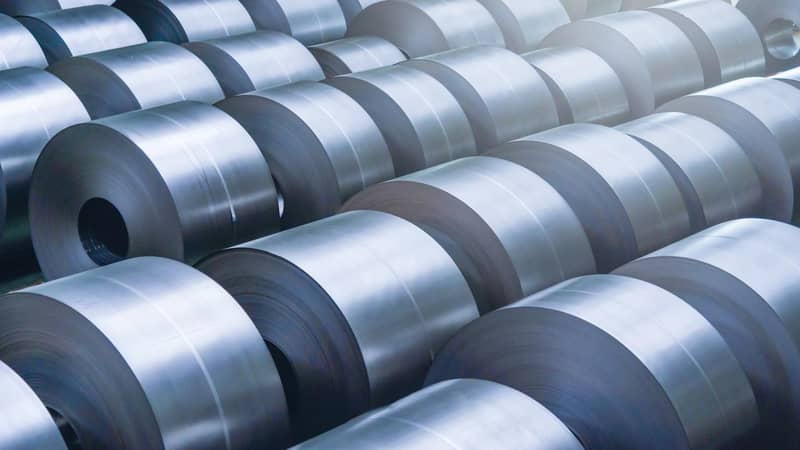 Rolled steel coils in a factory.