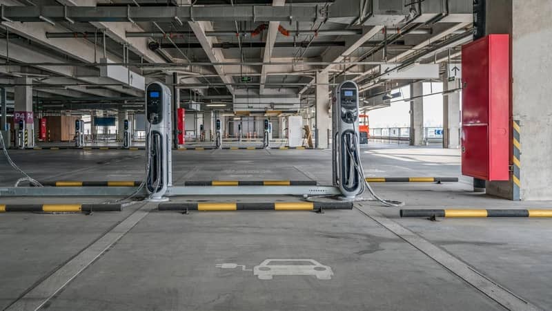 An empty car parking complex, with electrical vehicle charging stations at each bay.