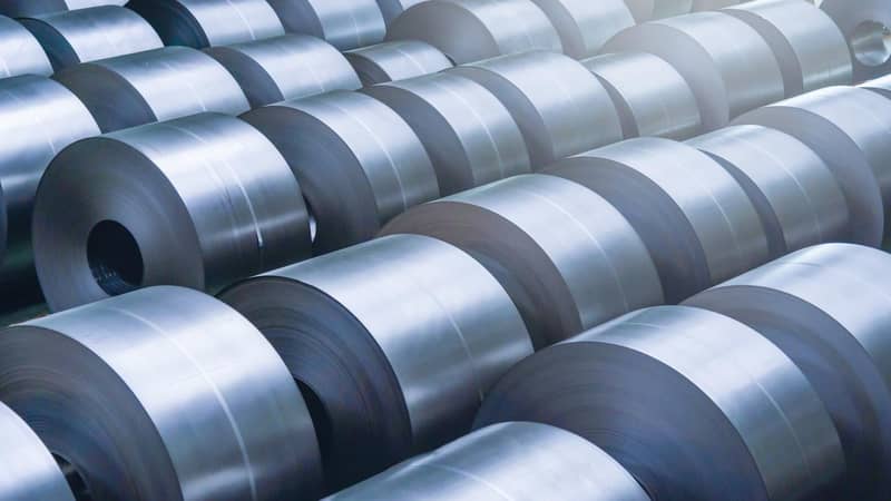 Rolled steel coils in a factory.