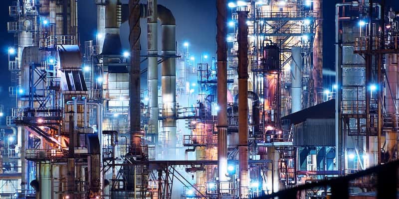 Vast illuminated refinery at night. 