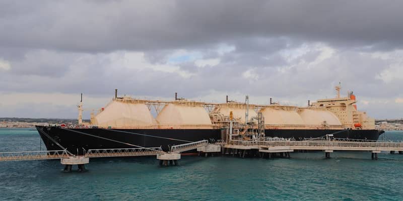 A Liquified Natural Gas Floating Storage Unit delivers LNG to the onshore regasification plant feeding natural gas to the power plant.