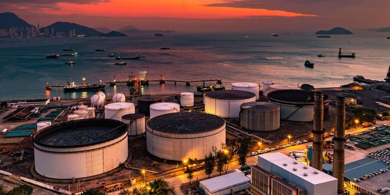 The tank is in the light of the industrial area. With the sky of the sunset.