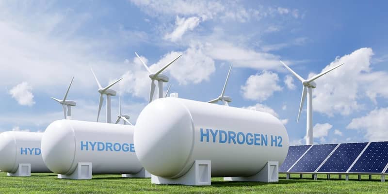 A render of a group of hydrogen tanks, solar panels and wind turbines.