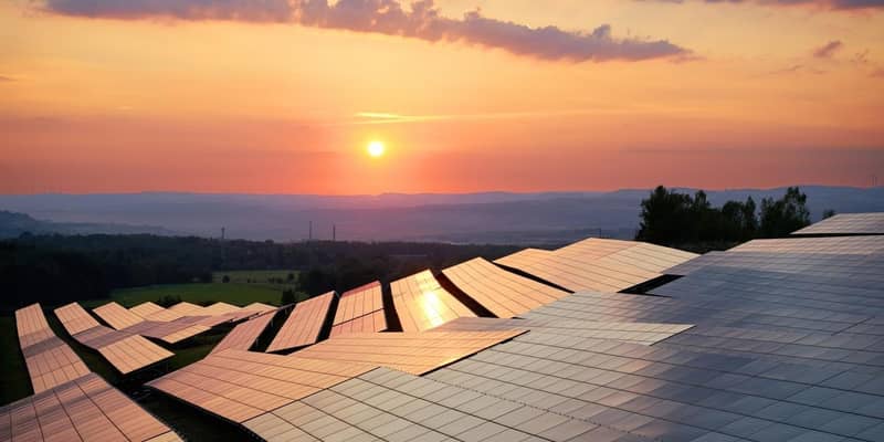 Rows of solar panels on hilltops during sunset.
