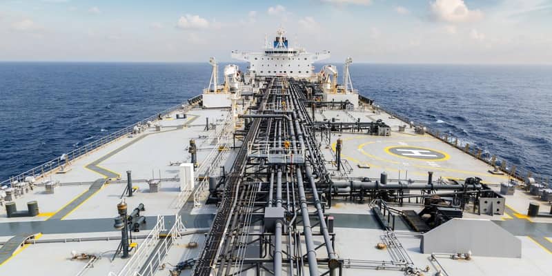 The deck of a large oil tanker in the ocean.