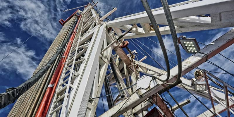 Central drilling column of an oil rig, against the blue skies.