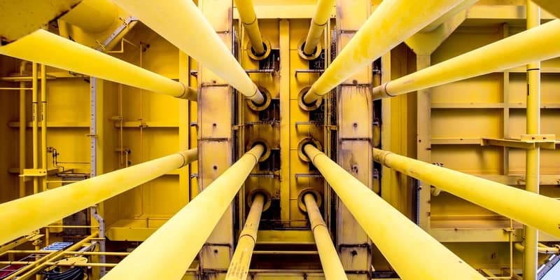 A close-up of a yellow pipes on an oil rig.