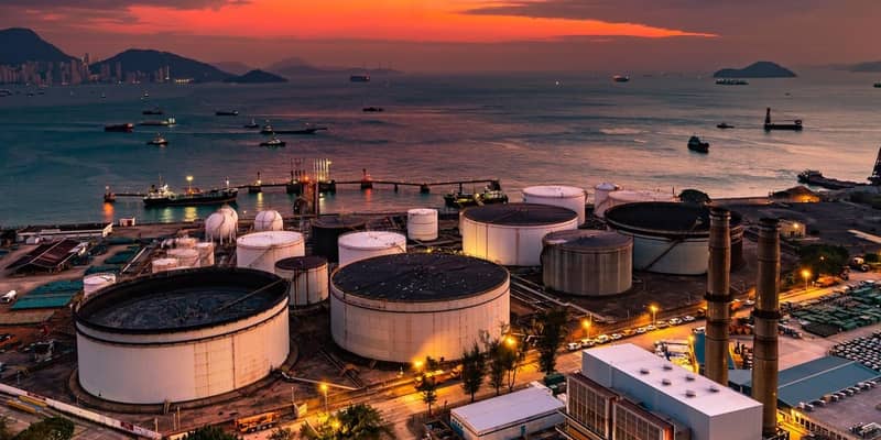 The tank is in the light of the industrial area. With the sky of the sunset.