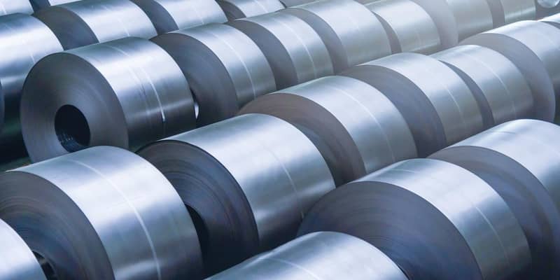 Rolled steel coils in a factory.