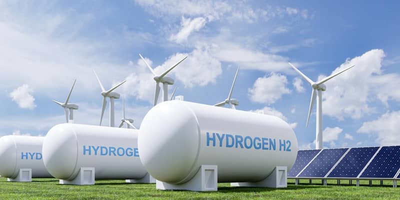 A render of a group of hydrogen tanks, solar panels and wind turbines.
