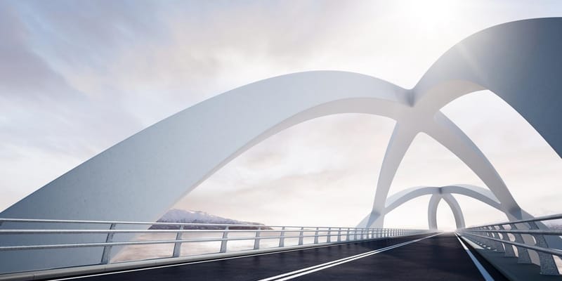 Modern curved architectural white bridge, against a backdrop of a river and mountain landscape on the left.