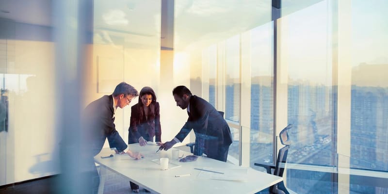 Adult senior diverse multi-ethnic Caucasian Hispanic Middle Eastern CEO executive team business people together in conference meeting room in contemporary modern office bright sunny daylight sunset dusk talking discussing planning organizing strategy well dressed suit and tie teamwork cooperation diversity multi-ethnic problems solutions unity cityscape downtown urban new beginnings breaking new ground dreamlike decisions choices the way forward diversity
