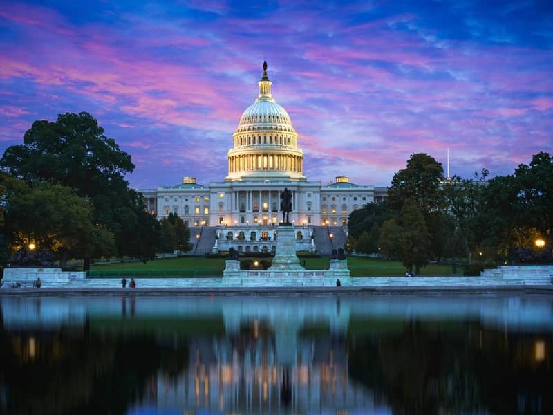 Capitol Hill Building and reflection in the Capitol Lake, at dusk. Washington DC, USA.