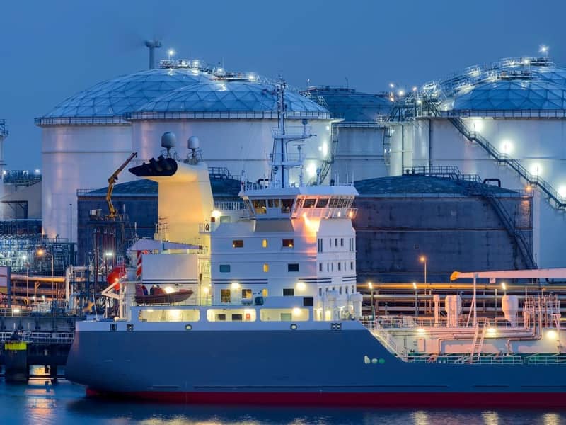 Liquid Natural Gas storage tanks and tanker at dusk, Port of Rotterdam.
