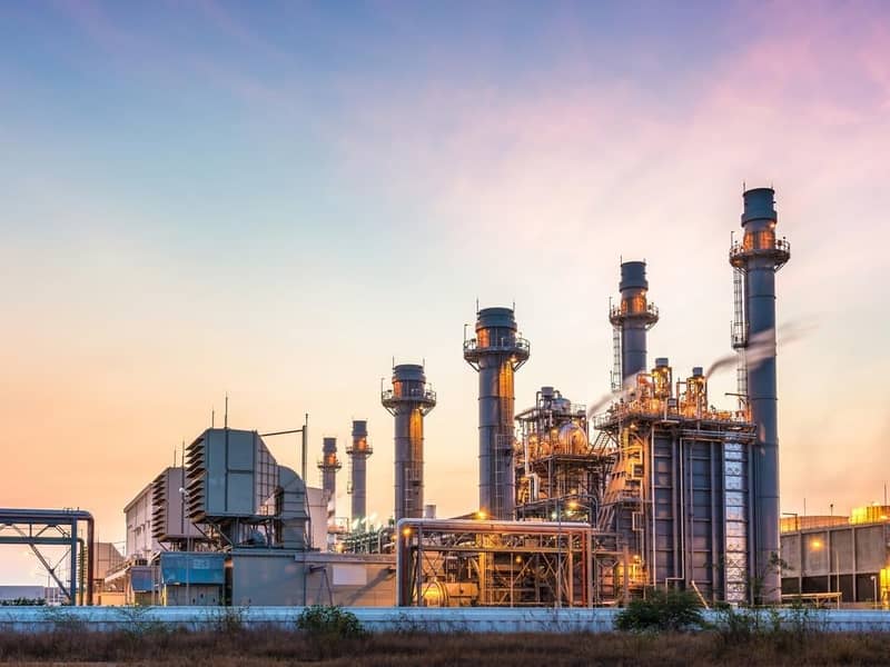 A large industrial plant at sunset.