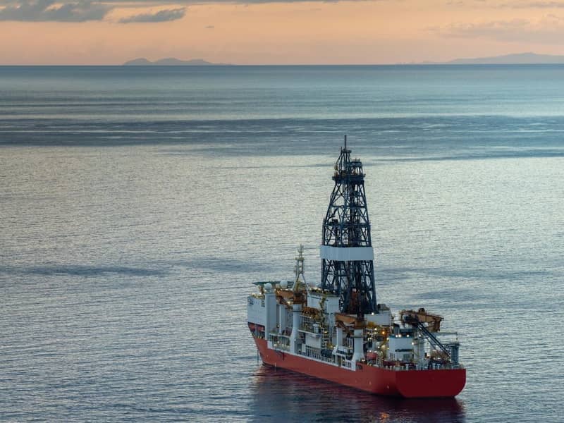 A large oil rig floating in the ocean.