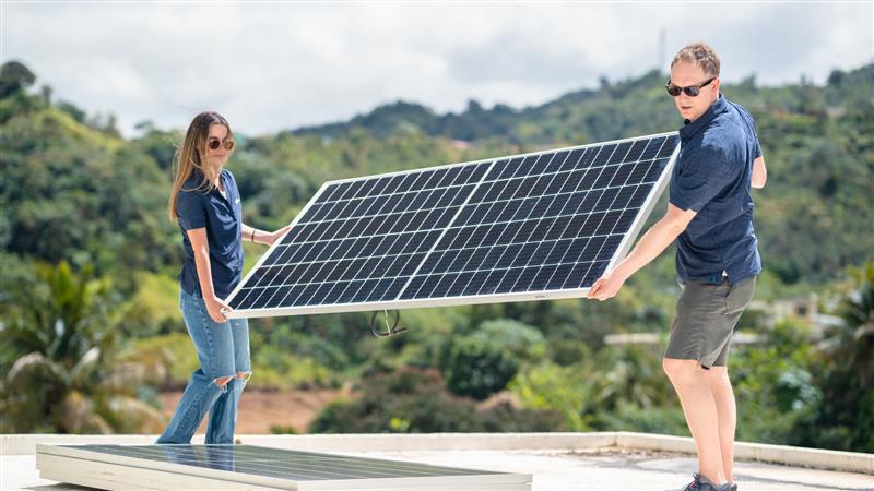 Woodmac volunteers fit solar panels