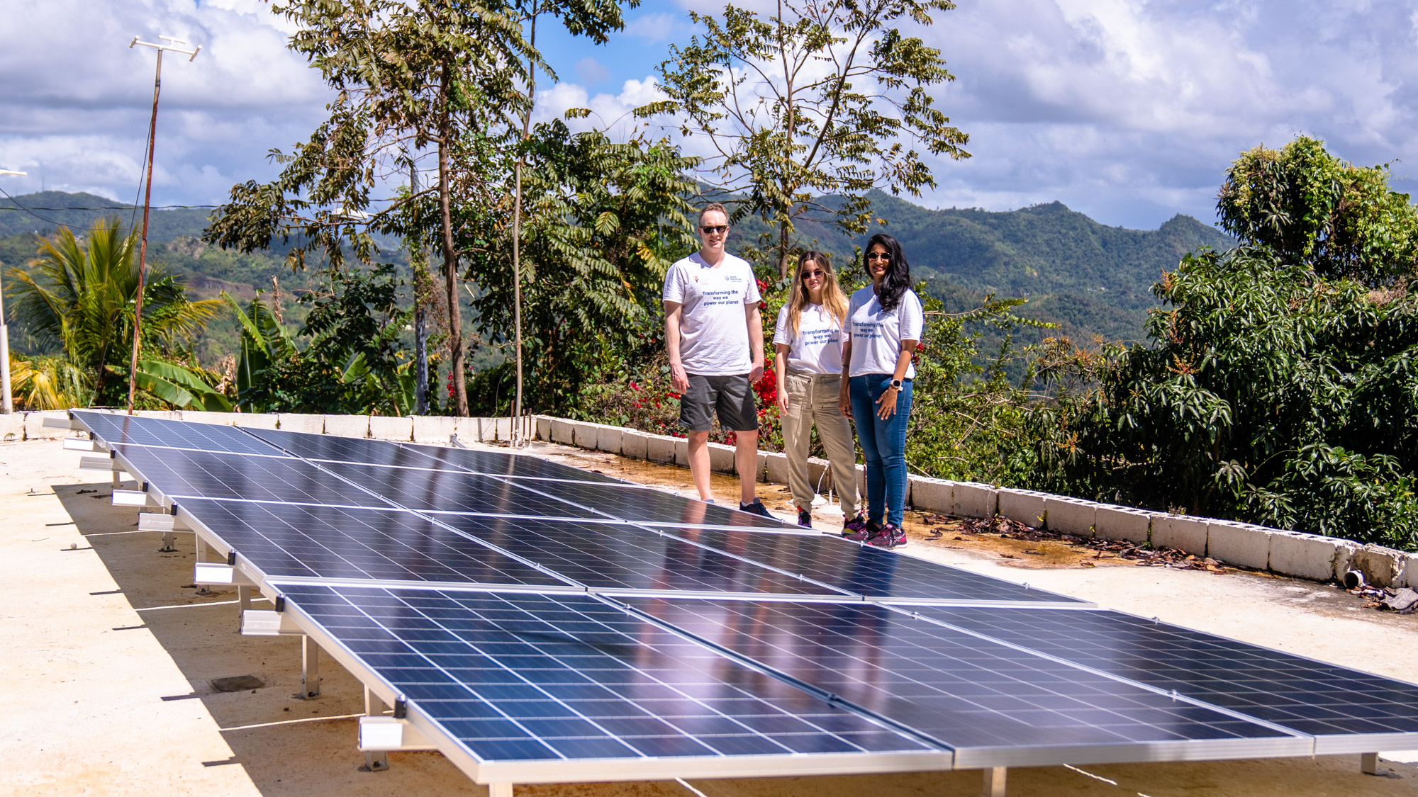 Image shows power lines and solar panels on a roof in Adjuntas