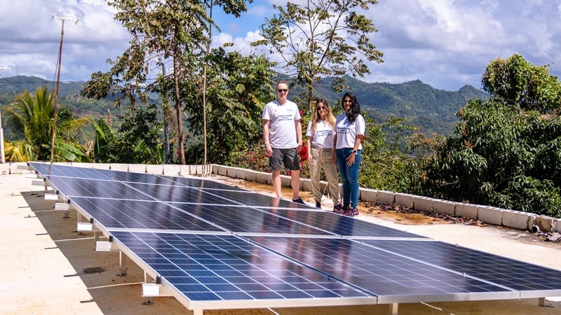 Image shows power lines and solar panels on a roof in Adjuntas