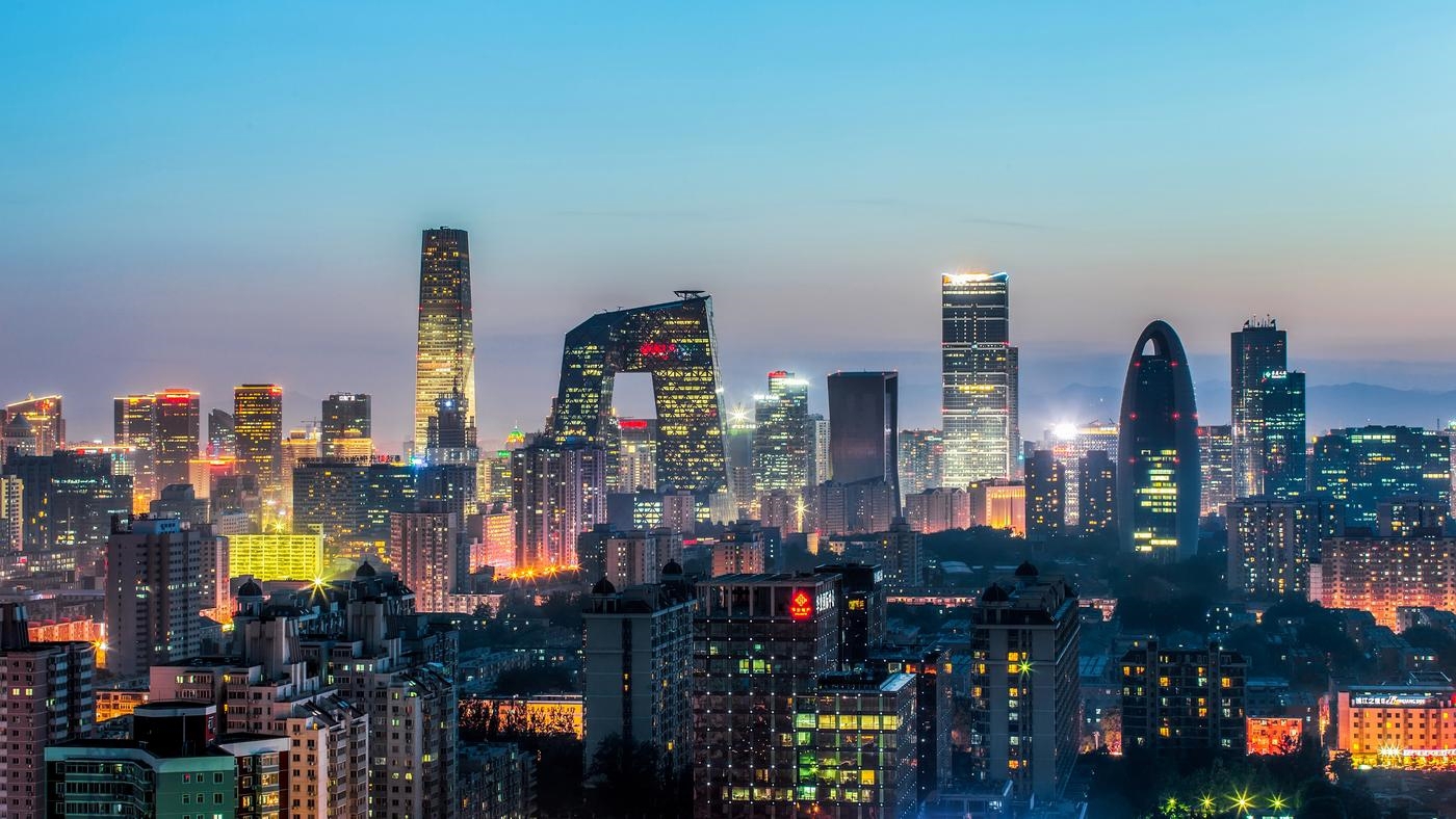 China World Trade Center and surrounding buildings at dusk, with a hazy blue-red sunset. Beijing, China.