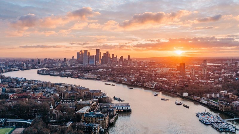 The River Thames and Canary Wharf at sunrise. London, UK.