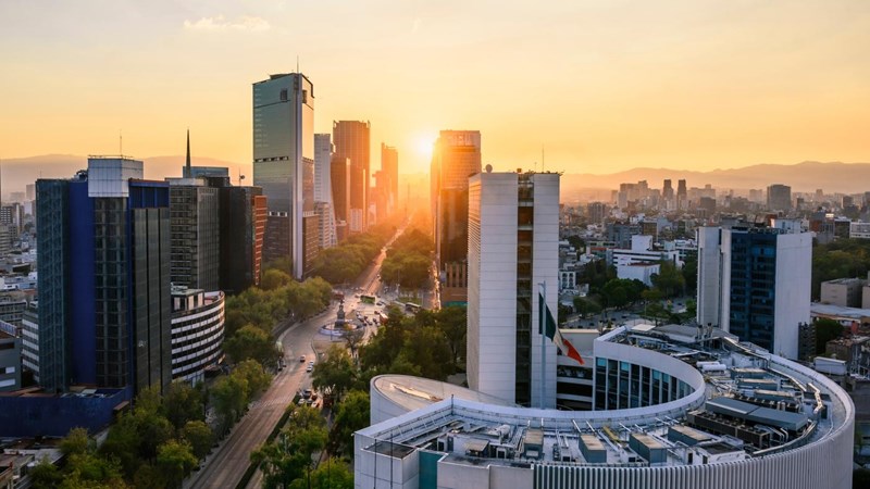 Office buildings, with the Popocatépetl mountains in the background at sunrise. Mexico City, Mexico.