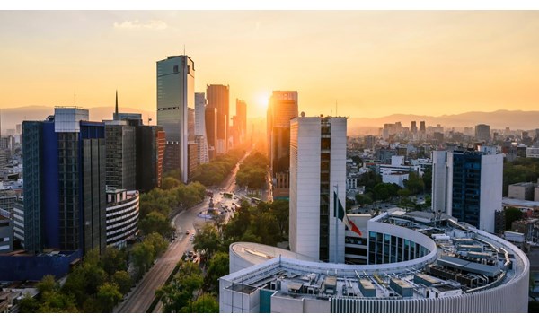Office buildings, with the Popocatépetl mountains in the background at sunrise. Mexico City, Mexico.