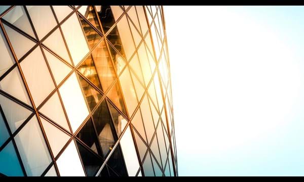 Close up of the Gherkin building exterior seen from below, one of the most recognizable skyscrapers in London.