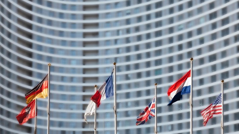 International flags in front of high-rise building.