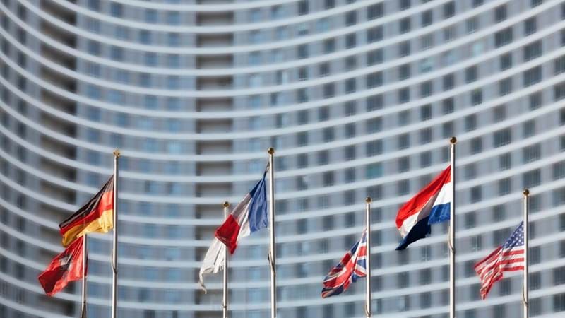 International flags in front of high-rise building.