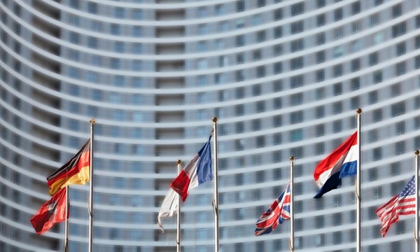 International flags in front of high-rise building.